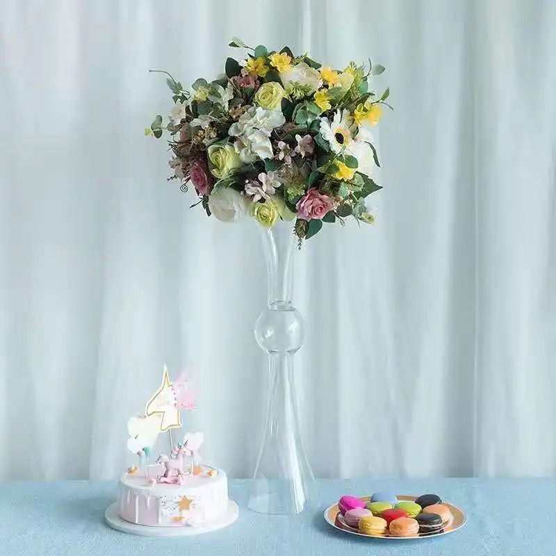 Floral centerpiece in tall vase, unicorn cake, macarons