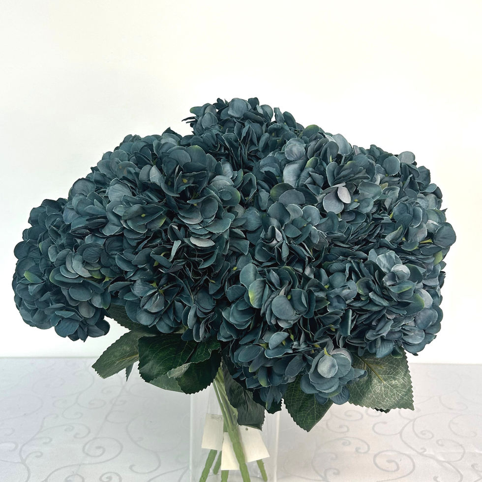 Bunch of dark blue hydrangeas in a glass vase; admire's furnishings.