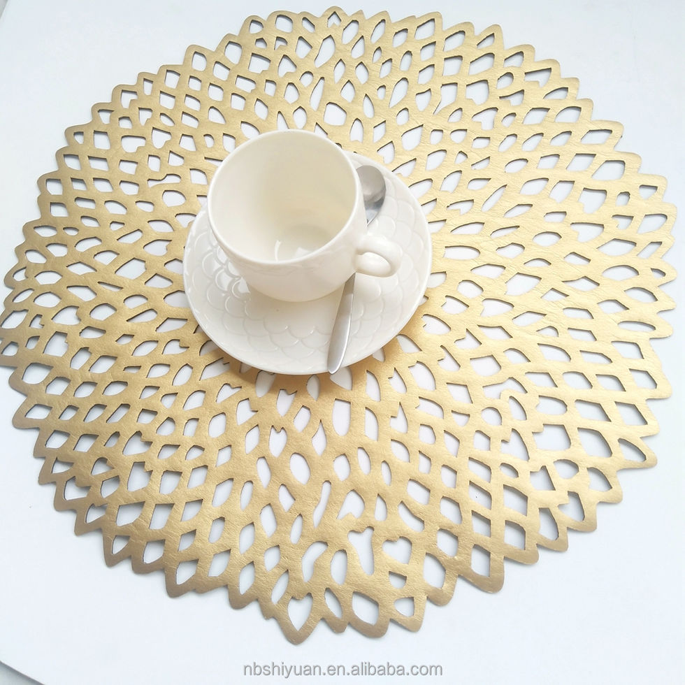Gold placemat with intricate design, teacup and spoon