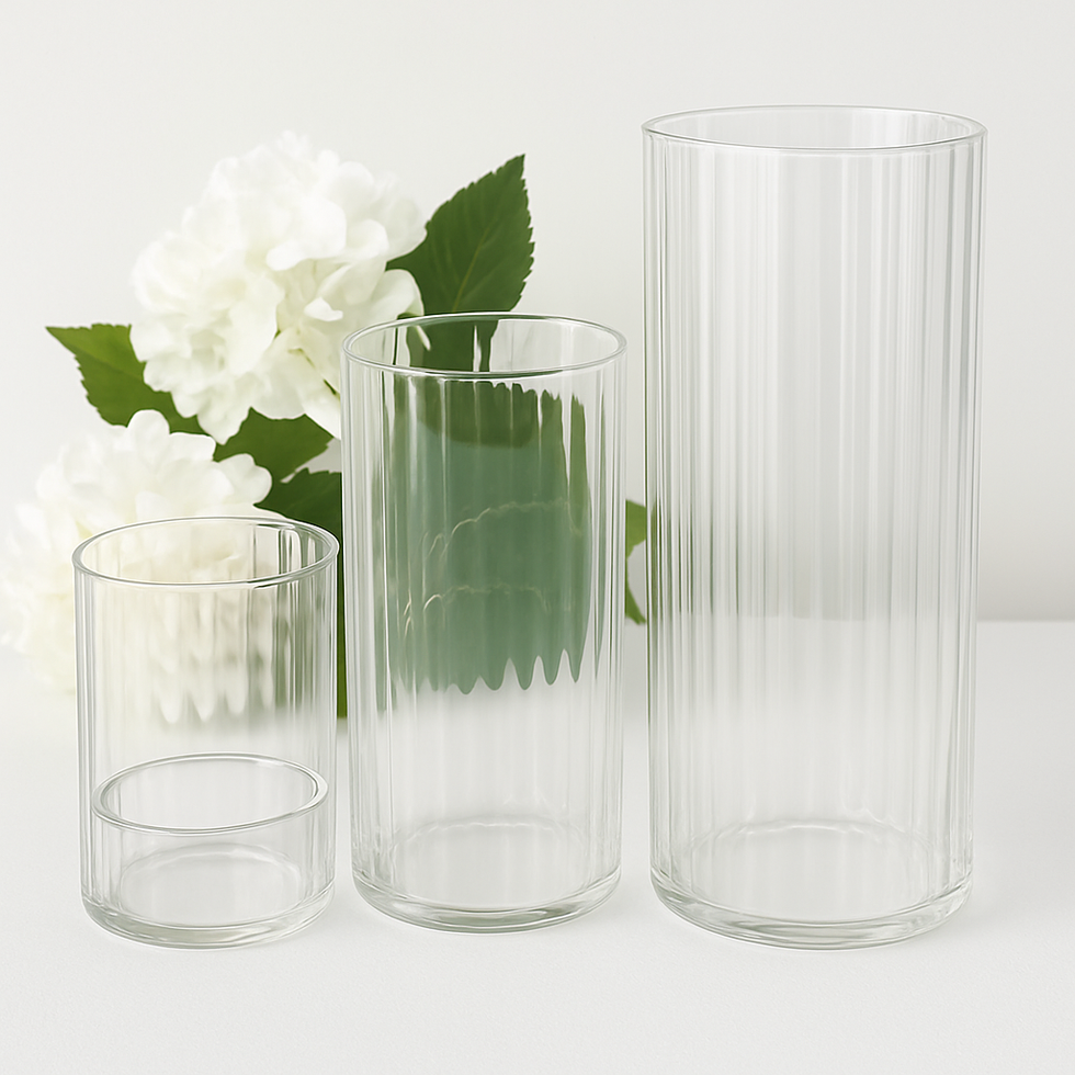Clear ribbed vases (set of 3) stand near white flowers; Admire's Furnishings