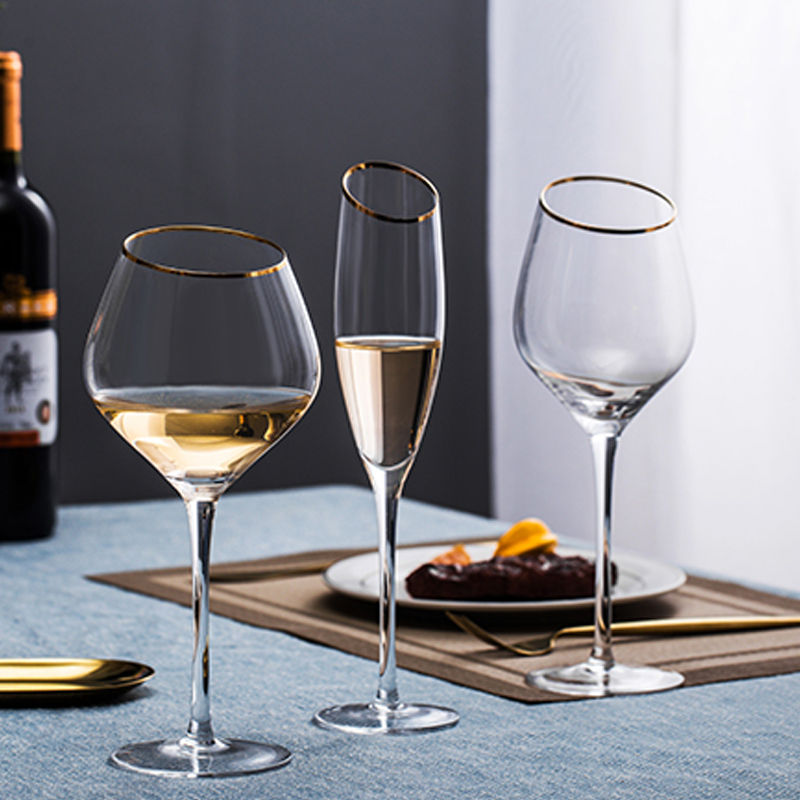 Elegant gold-rimmed wine glasses on table