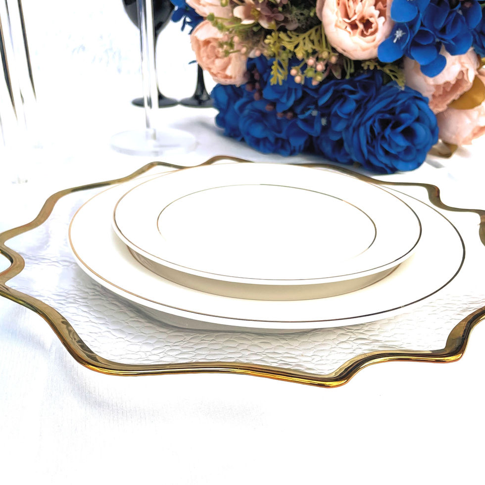 Elegant gold-rimmed plates, floral centerpiece