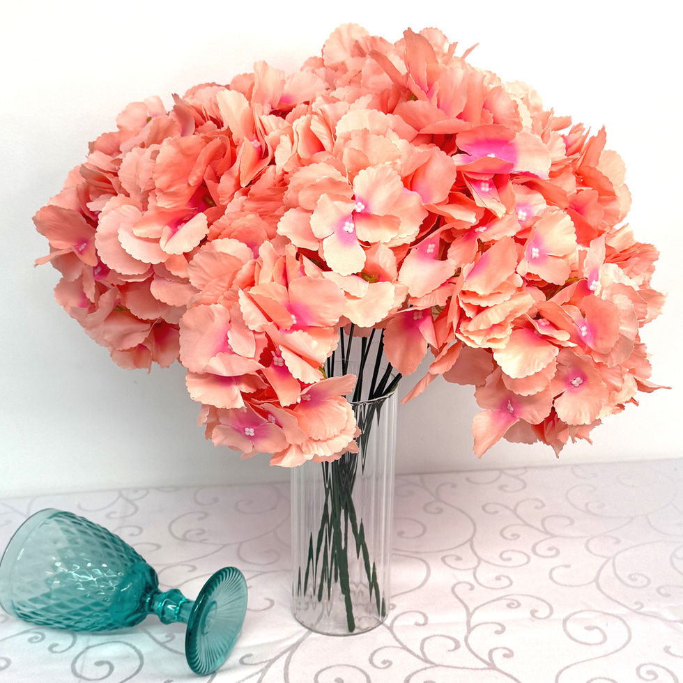 Bouquet of Light Lavender Pink Hydrangeas in a glass vase with green glass.