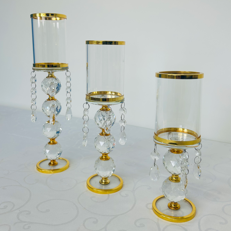Elegant glass candle holders, set of three, with gold accents and crystal embellishments. Admire's Furnishings