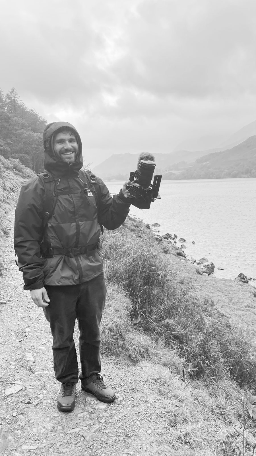Amon Shaw holding a camera mid-shoot in the Lake District UK