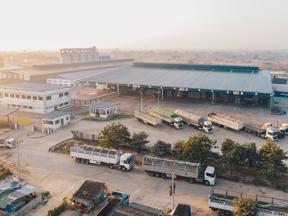 aerial-view-factory-trucks-parked-near-warehouse-daytime.jpg