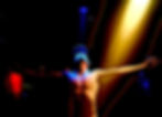 Shirtless person in blue light extends arms under a spotlight, creating a dramatic silhouette against a dark background. Ben Heyworth - The Cage, a music blog powered by Cage Riot