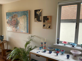 Picture entering the study, showing ceramics, mixed media and abstract paintings.
