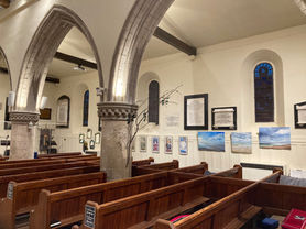 Front right of the church with stained glass animal mirrors