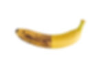 A banana is half ripe with brown spots and half yellow, against a white background. The split color highlights the ripening stages.