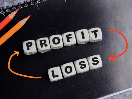 Dice spelling "PROFIT" and "LOSS" on a black notepad. Two pencils and curved arrows link words, highlighting financial theme.