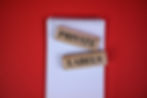Wooden blocks labeled "PRIVATE" and "LABELS" on a white notebook with red background.