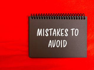 Black spiral notebook on bright red background with white text, MISTAKES TO AVOID.
