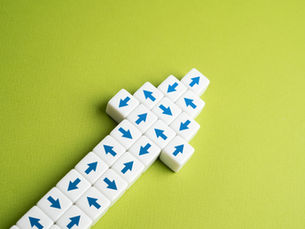 White cubes with blue arrows arranged diagonally on a lime green background, creating a clean abstract pattern.