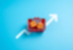 Red shopping basket with two boxes on blue background, white upward arrow suggesting growth or rising sales