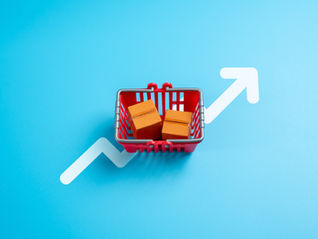 Red basket with two orange boxes on a blue background with a white rising arrow, symbolizing growth or progress.