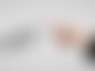 Human and robot hands nearly touch against a gray background, symbolizing connection between humanity and technology. Elegant, futuristic mood.