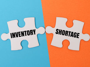White puzzle pieces on blue and orange background labeled INVENTORY and SHORTAGE, symbolizing supply problems