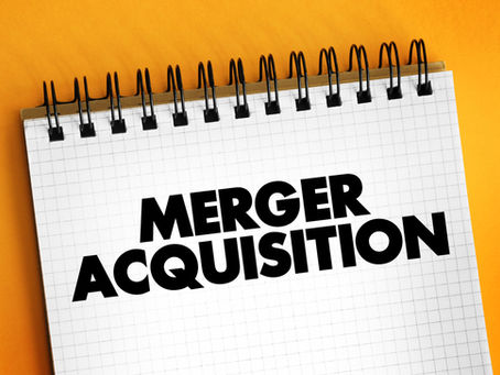 Notebook with "Merger Acquisition" on a grid page, spiral-bound. Set against a vibrant orange background.