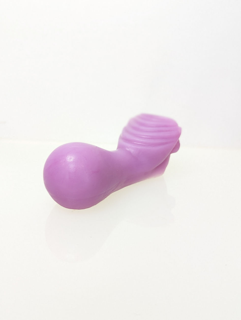 Thumbnail: Alt Isometric view of a purple silicon ride on grinder with inclined ridge facing up, bulbous end, and dip for pubic comfort