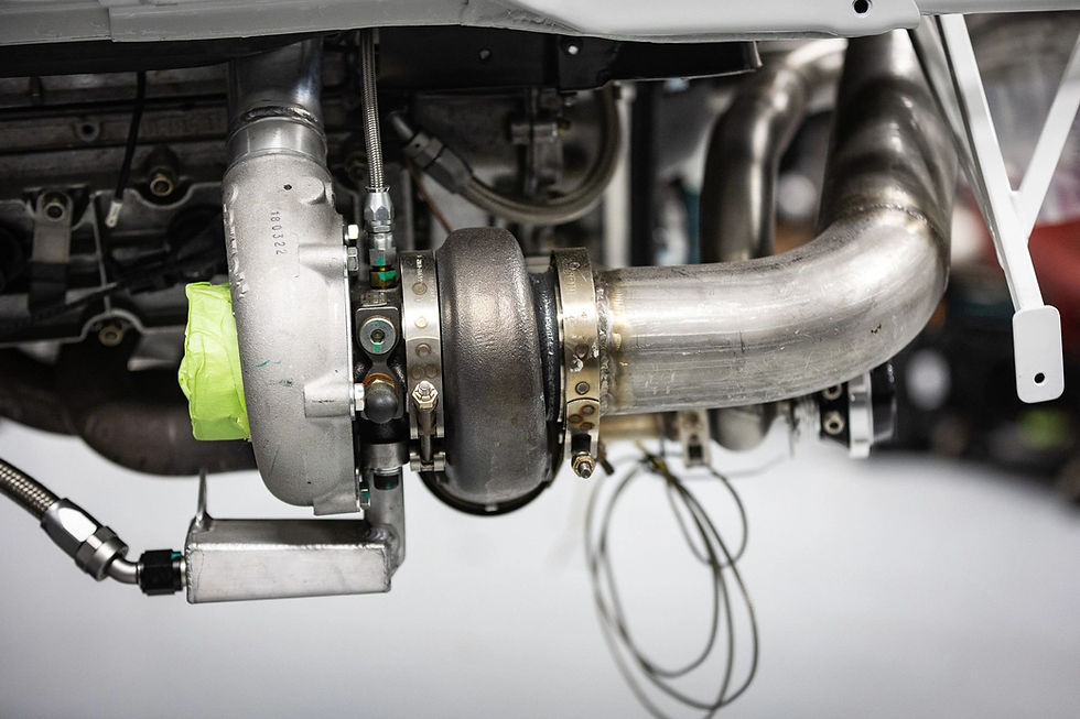 Turbocharger and exhaust piping in a road cars engine bay
