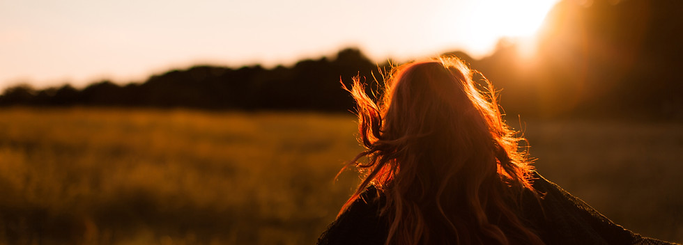 Girl Running in Field at Sunset