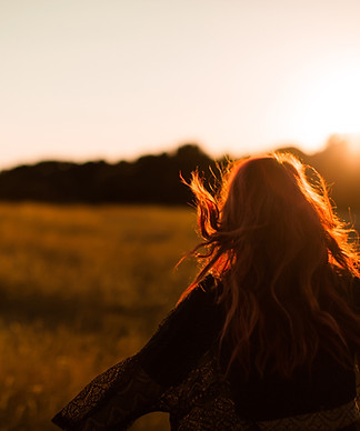 Girl Running in Field at Sunset