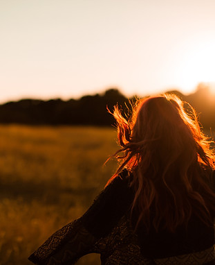 Girl Running in Field at Sunset