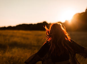 Girl Running in Field at Sunset