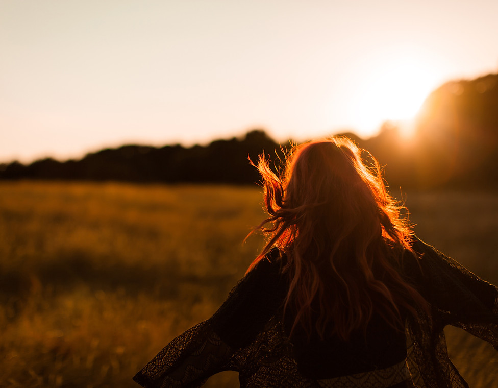 Girl Running in Field at Sunset