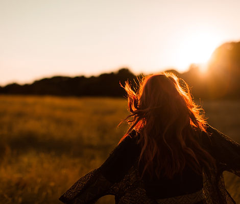 Girl Running in Field at Sunset