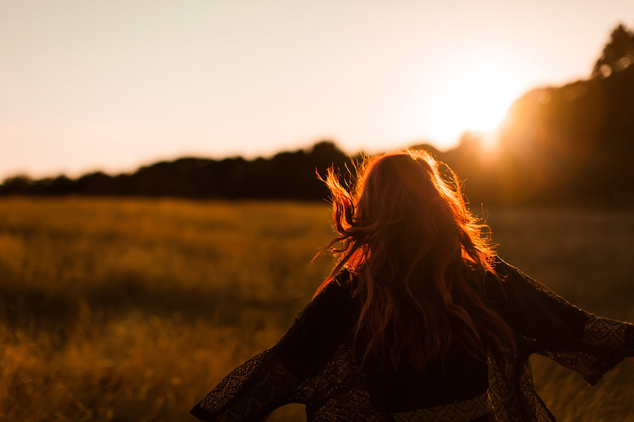 Girl Running in Field at Sunset