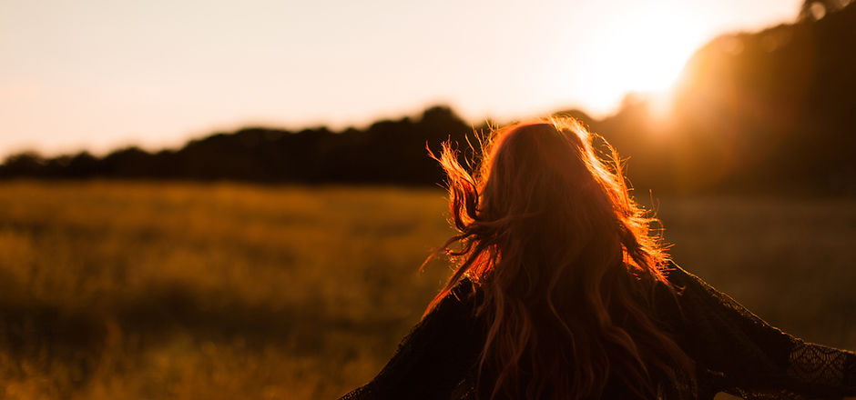 Girl Running in Field at Sunset