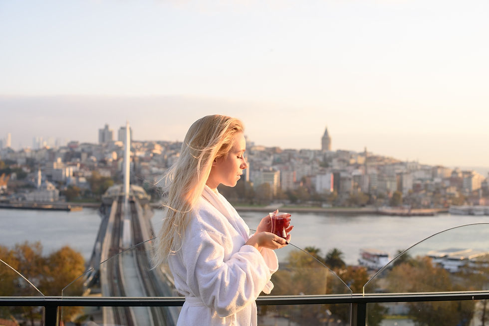 A woman is enjoying a Turkish tea overlooking the Bosphorus in Istanbul