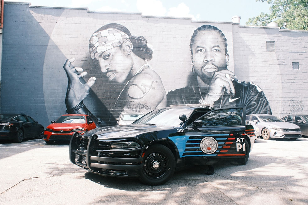 APD police cars against an Outkast mural in Atlanta