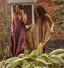 two girls wearing a silk jumpsuit
