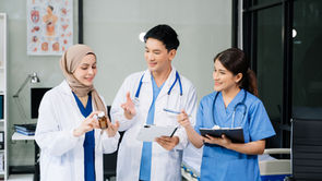 Healthcare professionals discussing medication and patient information in a clinical setting