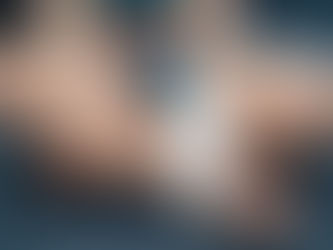 Child with a wrapped injured foot sits cross-legged on dark fabric. Wearing a colorful striped shirt and blue shorts, hands resting on legs. Joyful Seeds Paediatric and Developmental Clinic located in Bukit Timah