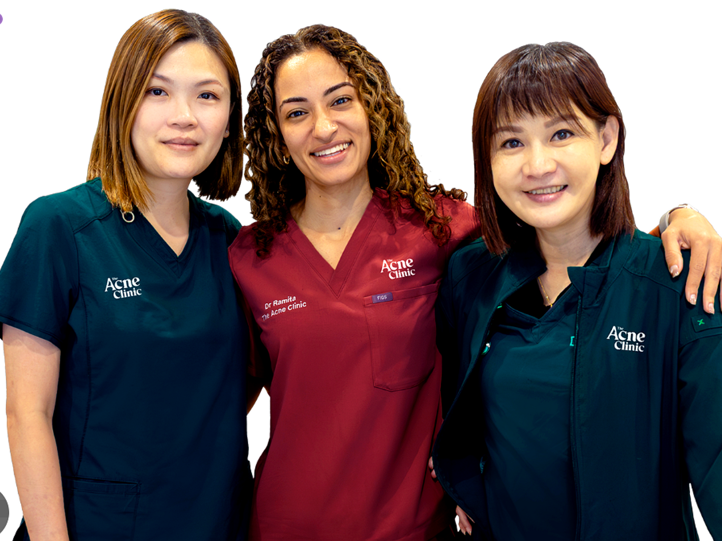 The Acne Clinic Singapore medical team in clinical attire posing for professional group portrait.
