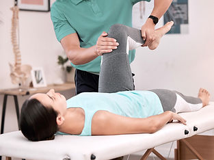 Physiotherapist performing guided leg stretches on a patient during rehabilitation therapy at AquaPhysio Rehab Center, Camden Medical Centre, Singapore.