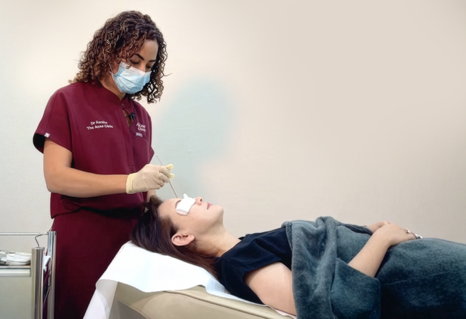 Acne doctor in Singapore performing a facial procedure at The Acne Clinic in i12 Katong.