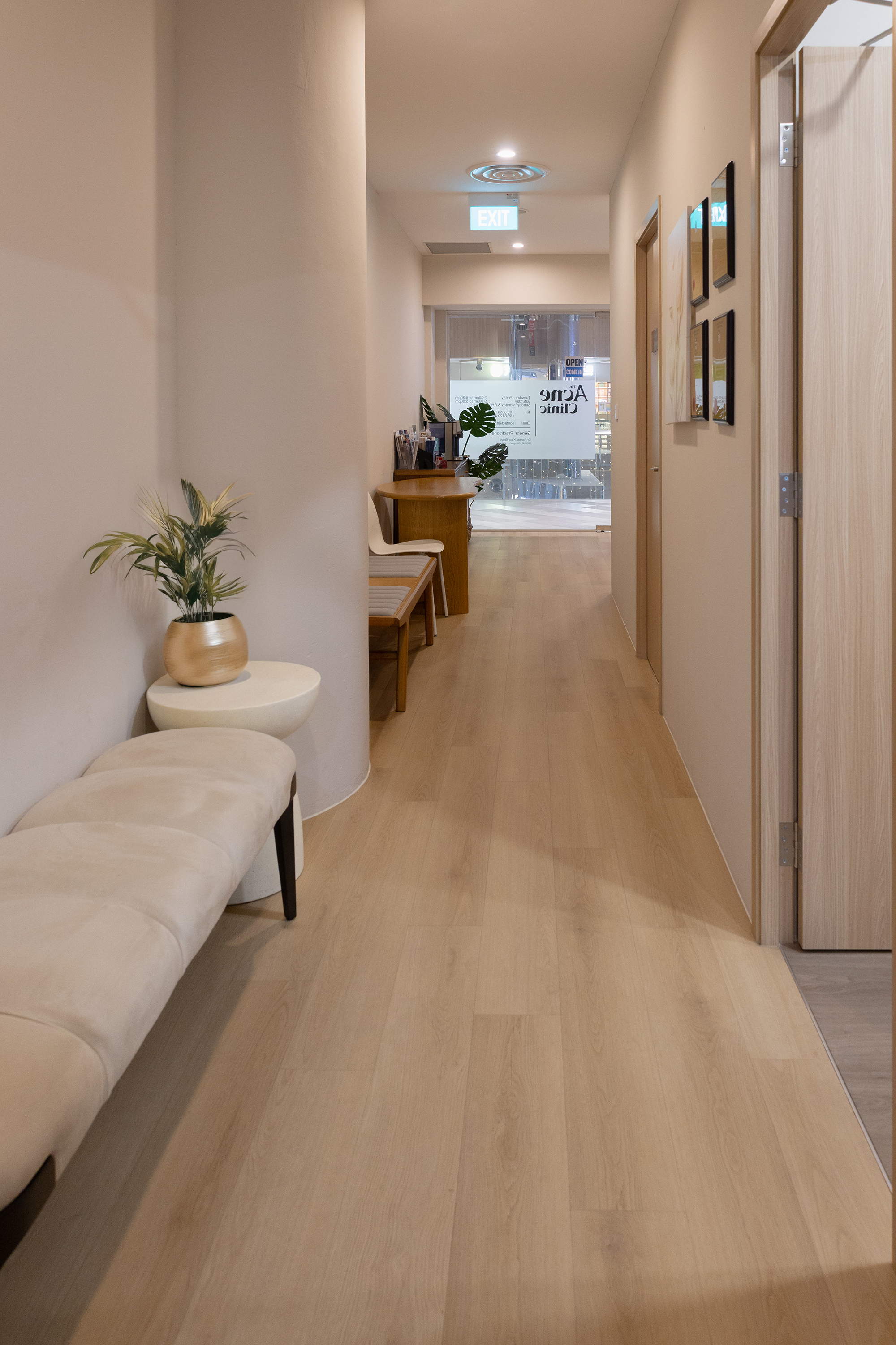 Hallway inside The Acne Clinic in i12 Katong Singapore with seating and warm modern decor.