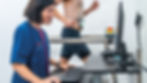 Doctor monitoring computer while a man runs on a treadmill