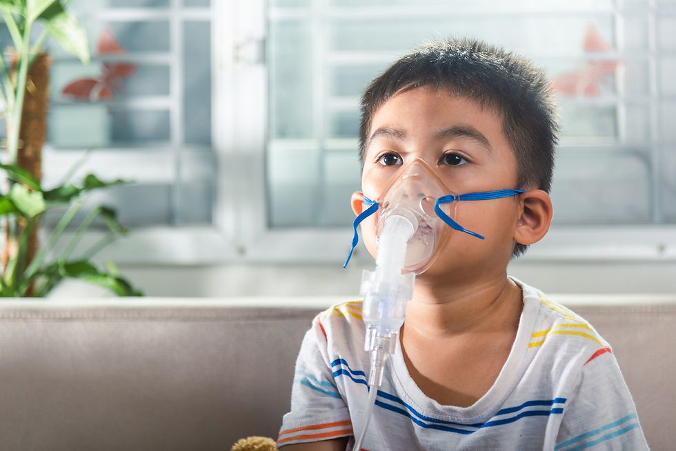 Young boy wearing a striped shirt uses a nebulizer in a bright room with plants and a window. Calm expression, focus on breathing treatment. Joyful Seeds Paediatric and Developmental Clinic located in Bukit Timah