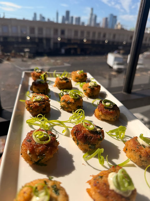Appetizers on a tray with a city skyline view