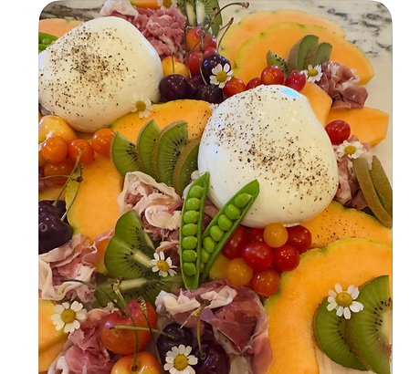 Burrata cheese platter with melon, prosciutto, and snap peas.