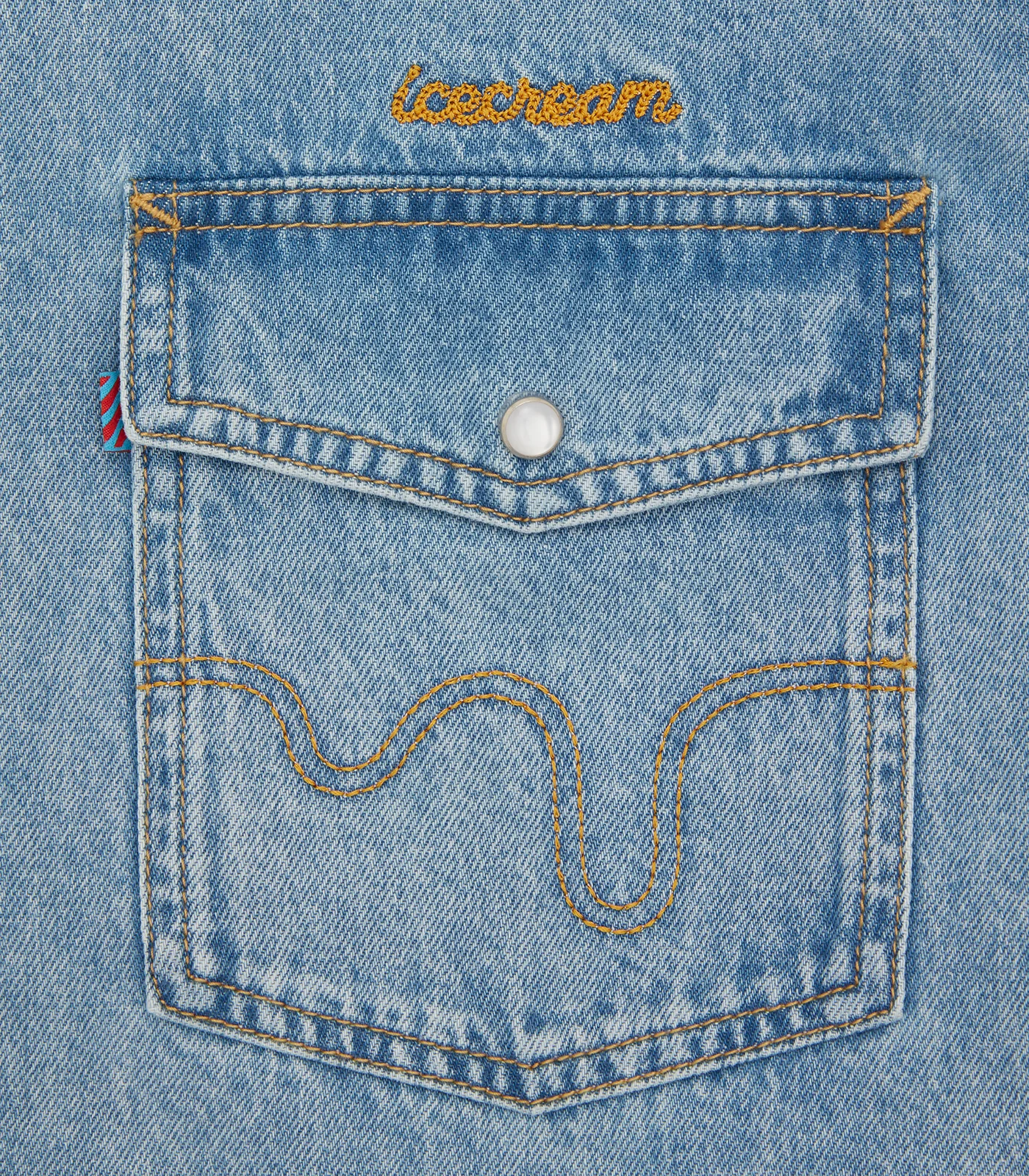 Ram Charan light wash denim shirt pocket embroidery close-up