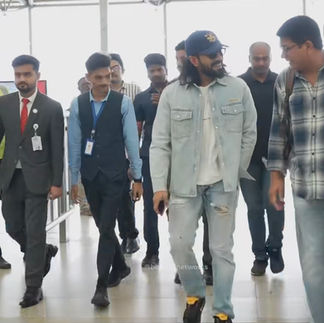 Ram Charan light wash denim shirt walking through airport