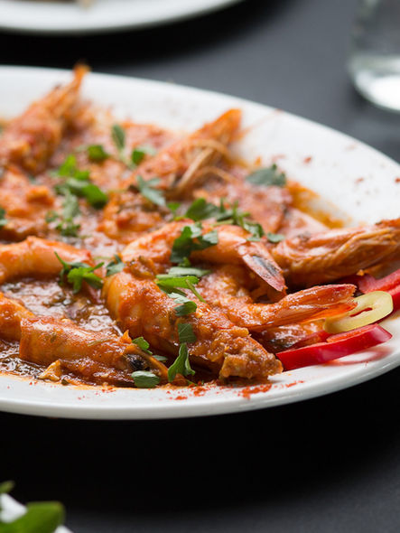 greek plates on a table, food photography, shrimps