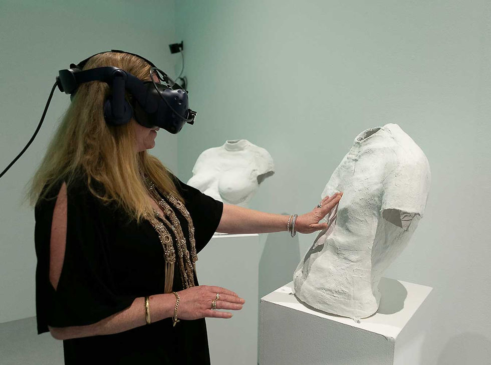 woman wearing vr headset touching a sculpt